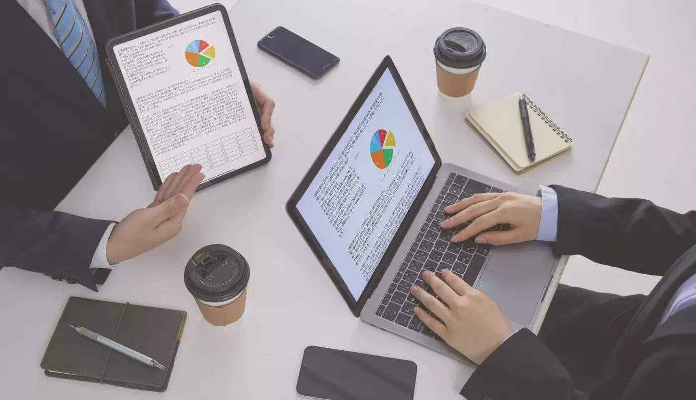 Business team reviewing performance charts on laptops and a tablet